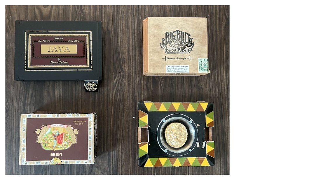 Four cigar boxes on a dark wood bench